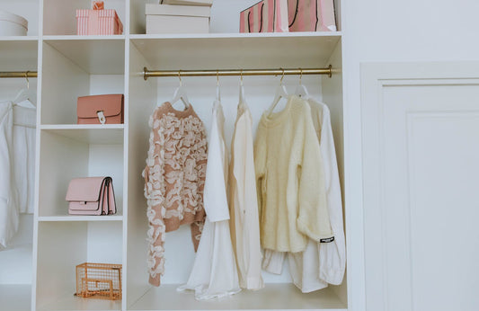 Clothes hanged inside a white closet